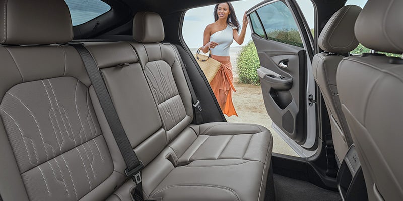 A women opened door of car and which have luxurious seats