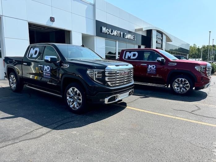 McLarty Daniel GMC trucks in front of car dealership